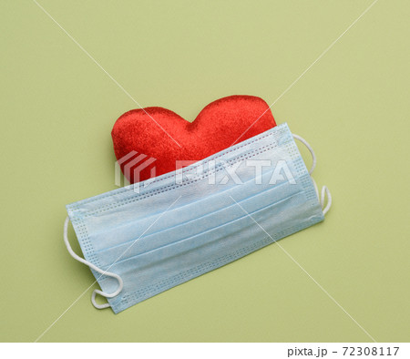 disposable masks on a green background, hygiene and virus protection accessories disposable masks on a green background, hygiene and virus protection accessories 72308117