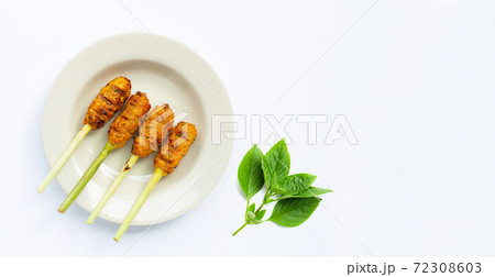 Grilled minced chicken with curry paste and coconut cream on lemongrass skewers. Top view 72308603