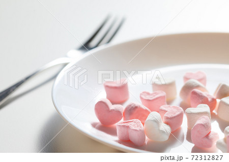 Heart shaped plate with heart shaped marshmallows, flat lay. Stock Photo by  puhimec