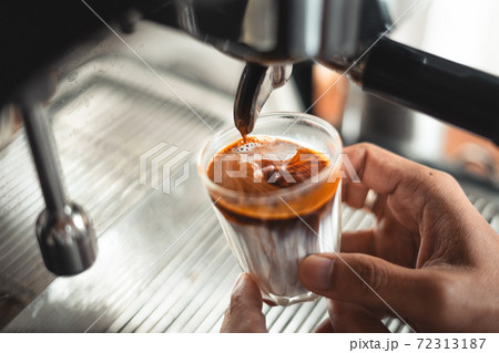 Milk and coffee in a glass from the maker Milk and coffee in a glass from the maker 72313187