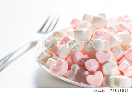 Heart shaped plate with heart shaped marshmallows, flat lay. Stock Photo by  puhimec