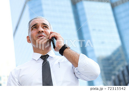 stock trader, investor, businessman talking on the mobile phone as worried about trade war news and disappointed from losing stock market after checking investment portfolio. business and financial. stock trader, investor, businessman talking on the mobile phone as worried about trade war news and disappointed from losing stock market after checking investment portfolio. business and financial. 72315542