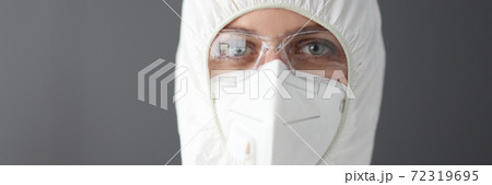 Doctor in protective antiplague suit, glasses and respirator portrait Doctor in protective antiplague suit, glasses and respirator portrait 72319695