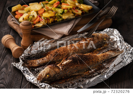Homemade grilled labrax served with stewed vegetables. Homemade grilled labrax served with stewed vegetables. 72320276