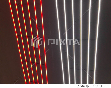 Blurred, no focused, abstract festive vertical background with red, orange and white neon led stripes on a black background, photography for creative workspace for design Blurred, no focused, abstract festive vertical background with red, orange and white neon led stripes on a black background, photography for creative workspace for design 72321099