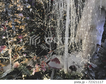New Year's decorations for the shopping center. artificial Christmas trees covered with snow. polar bears in a snowdrift. next to them are tall multi-colored mushrooms and illumination New Year's decorations for the shopping center. artificial Christmas trees covered with snow. polar bears in a snowdrift. next to them are tall multi-colored mushrooms and illumination 72321117