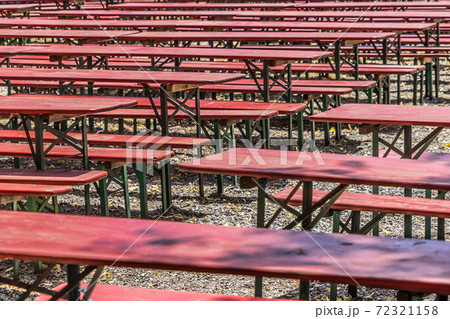 Ugly old red wooden benches and tables Ugly old red wooden benches and tables 72321158