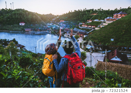 Couple Asian traveling together on mountain in Ban Rak Thai village countryside. Travel, camping in the winter, Outdoor relaxation, Romantic couples. Couple Asian traveling together on mountain in Ban Rak Thai village countryside. Travel, camping in the winter, Outdoor relaxation, Romantic couples. 72321524