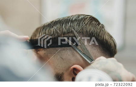 Barber with scissors and a comb Barber with scissors and a comb 72322092