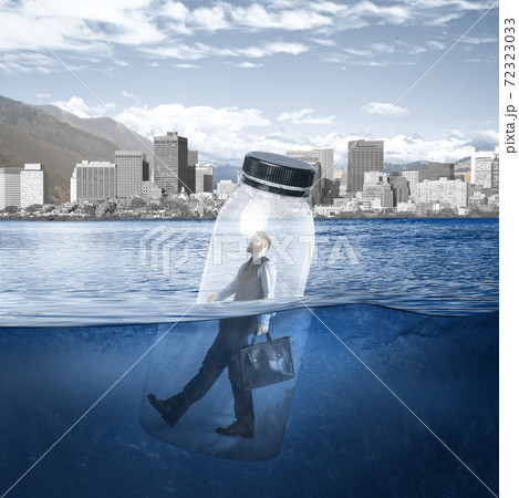 Office worker, businessman closed in bottle heading to work on the river with megapolis on the background Office worker, businessman closed in bottle heading to work on the river with megapolis on the background 72323033