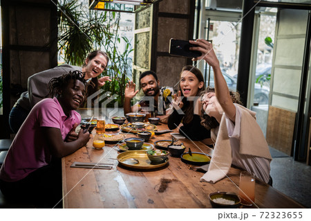 Group of students taking a self-portrait with the phone camera 72323655