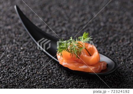 Salted salmon with dill on the background of black sesame. Salted salmon with dill on the background of black sesame. 72324192