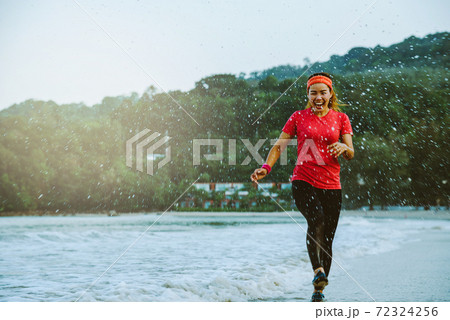 asian woman jogging workout on the beach in the morning. Relax with the beach. fun and happy with playing, jumping, kicking the sea. in summer asian woman jogging workout on the beach in the morning. Relax with the beach. fun and happy with playing, jumping, kicking the sea. in summer 72324256