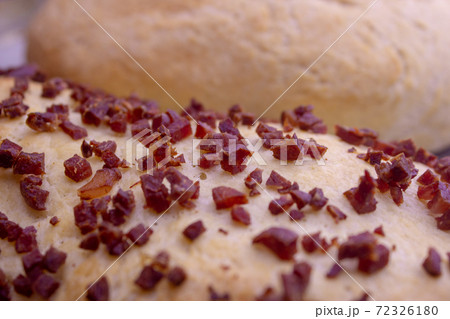 Fresh home baked breads, make out of wheat, one simple and one with pepperoni on top 72326180
