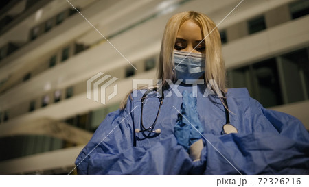 Exhausted american female medical intern preys for lives of coronavirus infected patients Exhausted american female medical intern preys for lives of coronavirus infected patients 72326216