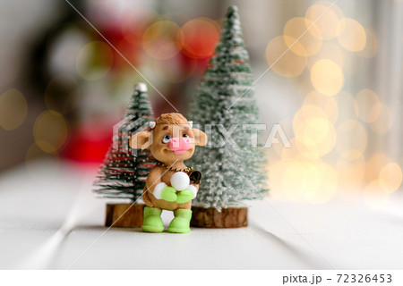 Beautiful multi-colored Christmas decorations on a light wooden table Beautiful multi-colored Christmas decorations on a light wooden table 72326453