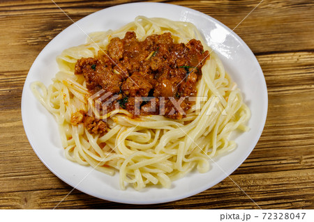 Pasta with bolognese sauce on wooden table 72328047