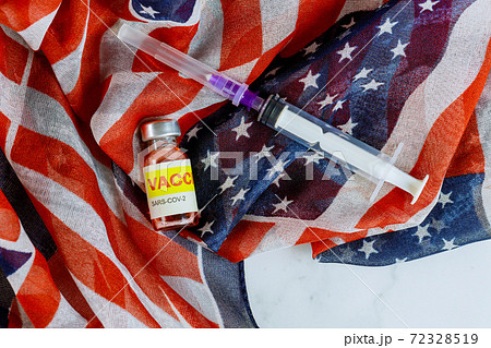 American vaccine in bottle and syringe for fight injection Sars-cov-2 coronavirus covid-19 with the US flag 72328519
