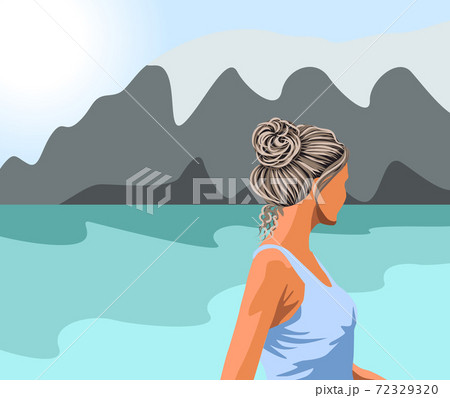 Gray haired woman in blue tank top looking at the lake and the mountains Gray haired woman in blue tank top looking at the lake and the mountains 72329320