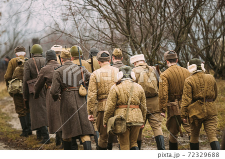Re-enactors Dressed As World War II Russian Soviet Red Army Soldiers Marching Through Forest. Soldier Of WWII WW2 Times 72329688