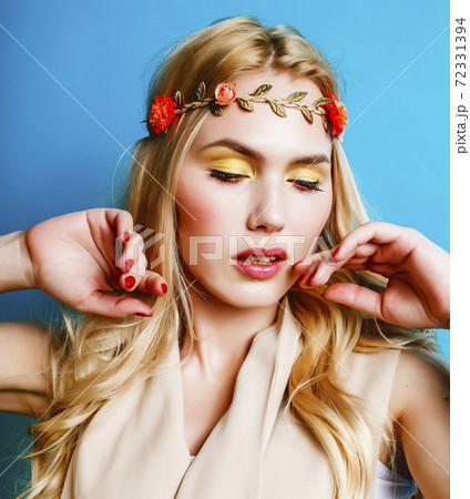 young blond woman dressed like ancient greek godess, jewelry close up isolated, beautiful girl hands manicured red nails on blue background copyspace young blond woman dressed like ancient greek godess, jewelry close up isolated, beautiful girl hands manicured red nails on blue background copyspace 72331394