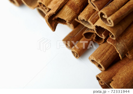 Cinnamon close up on a white background Cinnamon close up on a white background 72331944
