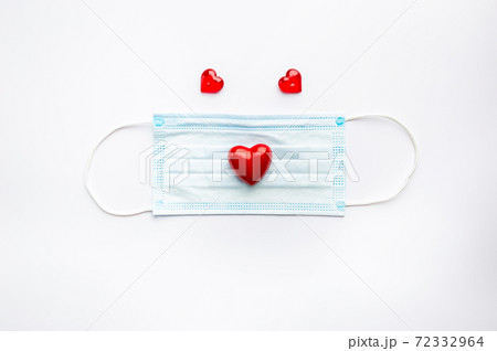 Medical face mask and red heart. Medical face mask and red heart. 72332964