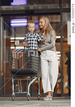 Mother with baby boy going shopping 72333773