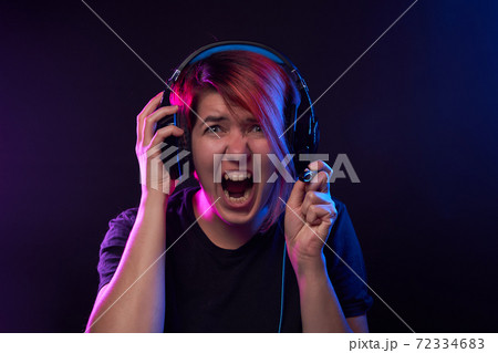Woman wearing gaming headset. Concept of virtual reality, games, entertainment and communication. 72334683