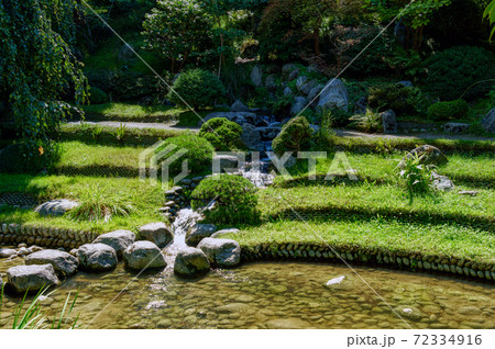 Stream and rocks in Albert Kahn Japanese Garden - Boulogne-Billancourt - France 72334916