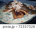 Trout with gravy in parmesan, spinach and roasted almonds . 72337326