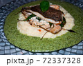 Sea bream fillet with spinach on a plate . 72337328