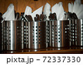 Metal glasses with cutlery and napkins , 72337330