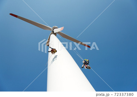 repair work on the blades of a windmill for electric power production - copy space repair work on the blades of a windmill for electric power production - copy space 72337380