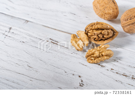 Walnuts kernels on white wooden desk, stock photo Walnuts kernels on white wooden desk, stock photo 72338161