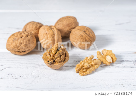 Walnuts kernels on white wooden desk, stock photo Walnuts kernels on white wooden desk, stock photo 72338174