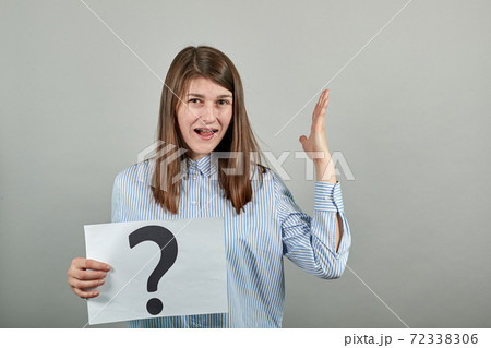 Black question mark on a piece of white paper. Close-up hand holding symbol Black question mark on a piece of white paper. Close-up hand holding symbol 72338306