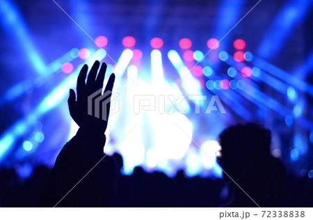 Raised hand at a live concert Raised hand at a live concert 72338838