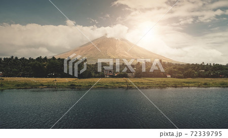 Volcano erupt at sun shine over lake shore aerial. Philippines coutryside of Legazpi town at valley 72339795