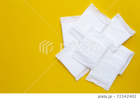White sanitary pads on yellow background. White sanitary pads on yellow background. 72342402