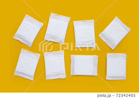 White sanitary pads on yellow background. White sanitary pads on yellow background. 72342403