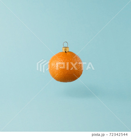 Christmas toy made from orange tangerine fruit. Minimal New Years concept. Levitation. Christmas toy made from orange tangerine fruit. Minimal New Years concept. Levitation. 72342544