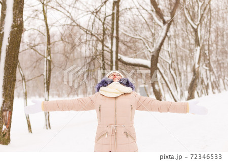 Young girl in a snowy forest in winter. Young girl in a snowy forest in winter. 72346533