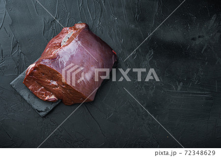 Raw beef liver on black background, flat lay with copy space Raw beef liver on black background, flat lay with copy space 72348629
