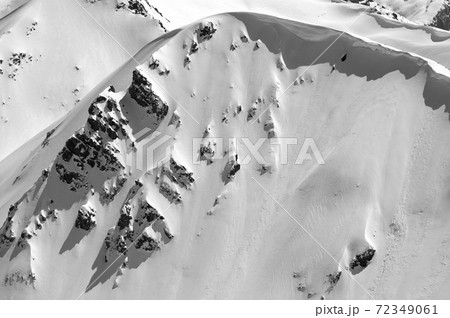 Snow cornice in winter mountains in cold sunny day 72349061