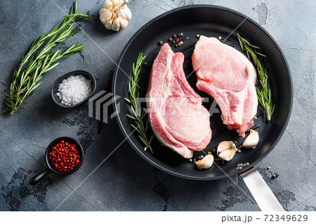 Cutlet on a rib pork in cast iron pan top view 72349629