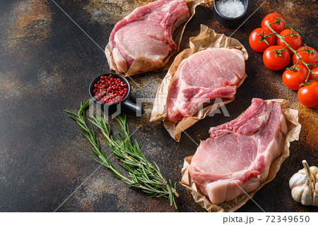 Tree bunch raw pork chops arranged with herbs, oil Tree bunch raw pork chops arranged with herbs, oil 72349650