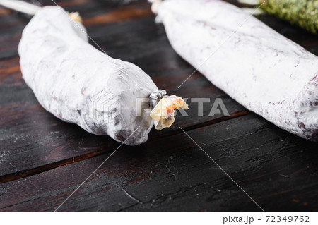 Spanish dry sausages on old wooden table Spanish dry sausages on old wooden table 72349762