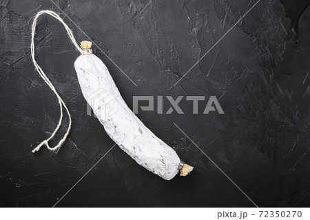 Salchichon, spanish salami sausage on black 72350270