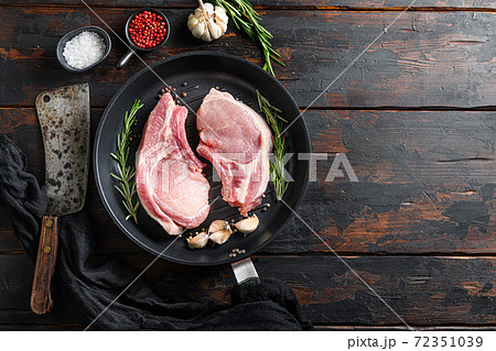 Raw pork pork rib roast in frying pan on a rustic 72351039